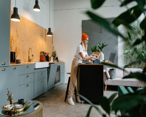 Woman adjusting laptop brightness in a modern Lima apartment